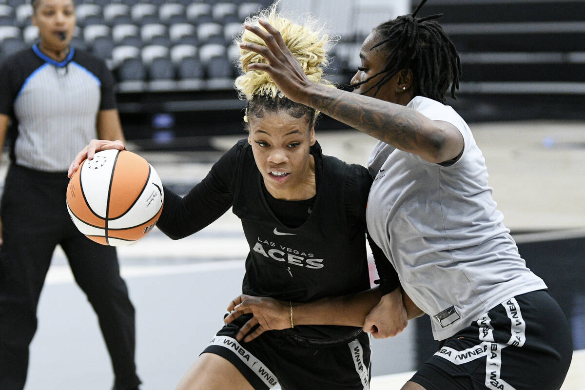 Harmoni Turner drives to the basket against Queen Egbo during the Las Vegas Aces first day of t ...
