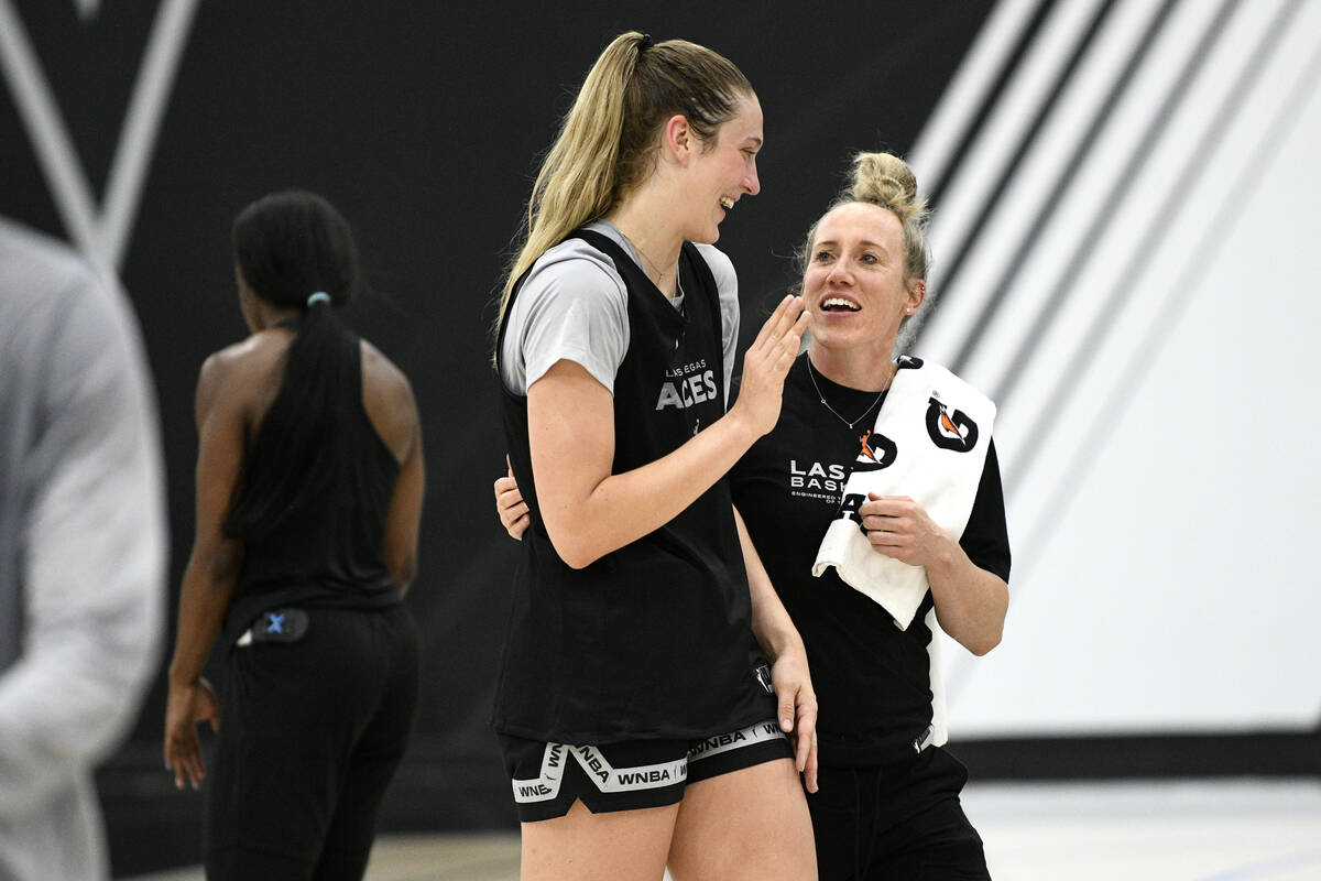 Elizabeth Kitley and director of health and performance Ciara Burgi laugh during the Aces first ...