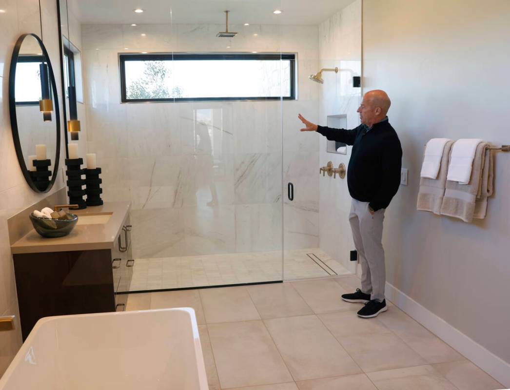Klif Andrews, division president of Tri Pointe Homes Las Vegas, leads a tour of one of La Cova' ...