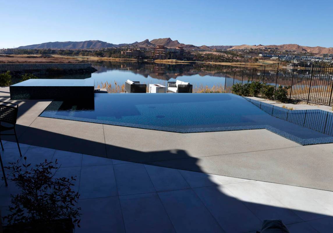 A contemporary swimming pool is seen at La Cova's two-story model home at South Shore Lake Las ...
