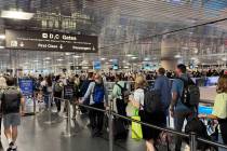 Travelers wait in long TSA lines at Harry Reid International Airport in Las Vegas on April 28, ...
