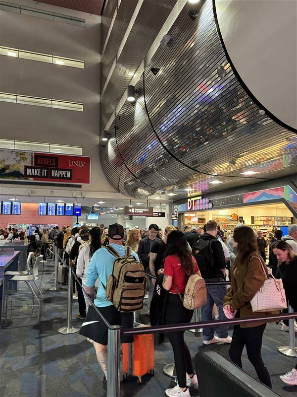 Travelers wait in long TSA lines at Harry Reid International Airport in Las Vegas on April 28, ...