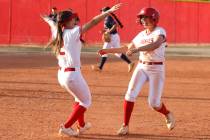 Arbor View high school softball players Breya Hee (2) and Madilyn Lowy (3) celebrate after Lowy ...