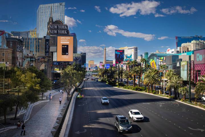A nearly empty sidewalk is seen as traffic moves southbound along the Strip Tuesday, April 29, ...