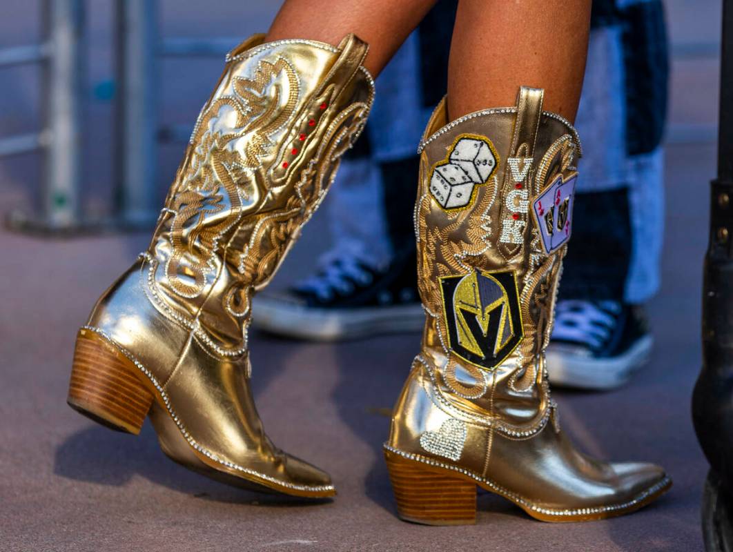 A Golden Knights fan sports golden boots and custom shorts while outside before game five again ...