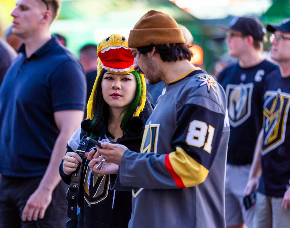 A Golden Knights fan wears a Chance the Gila Monster hat while outside before game five against ...