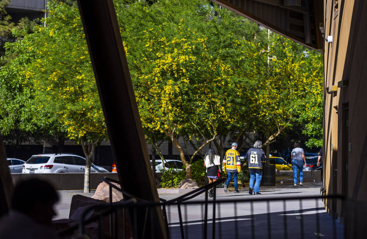 Golden Knights fans walk outside before game five against the Minnesota Wild in the Stanley Cup ...