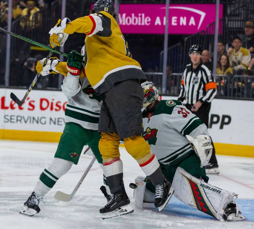 Golden Knights right wing Mark Stone (61) battles to Geta shot past Minnesota Wild goaltender F ...