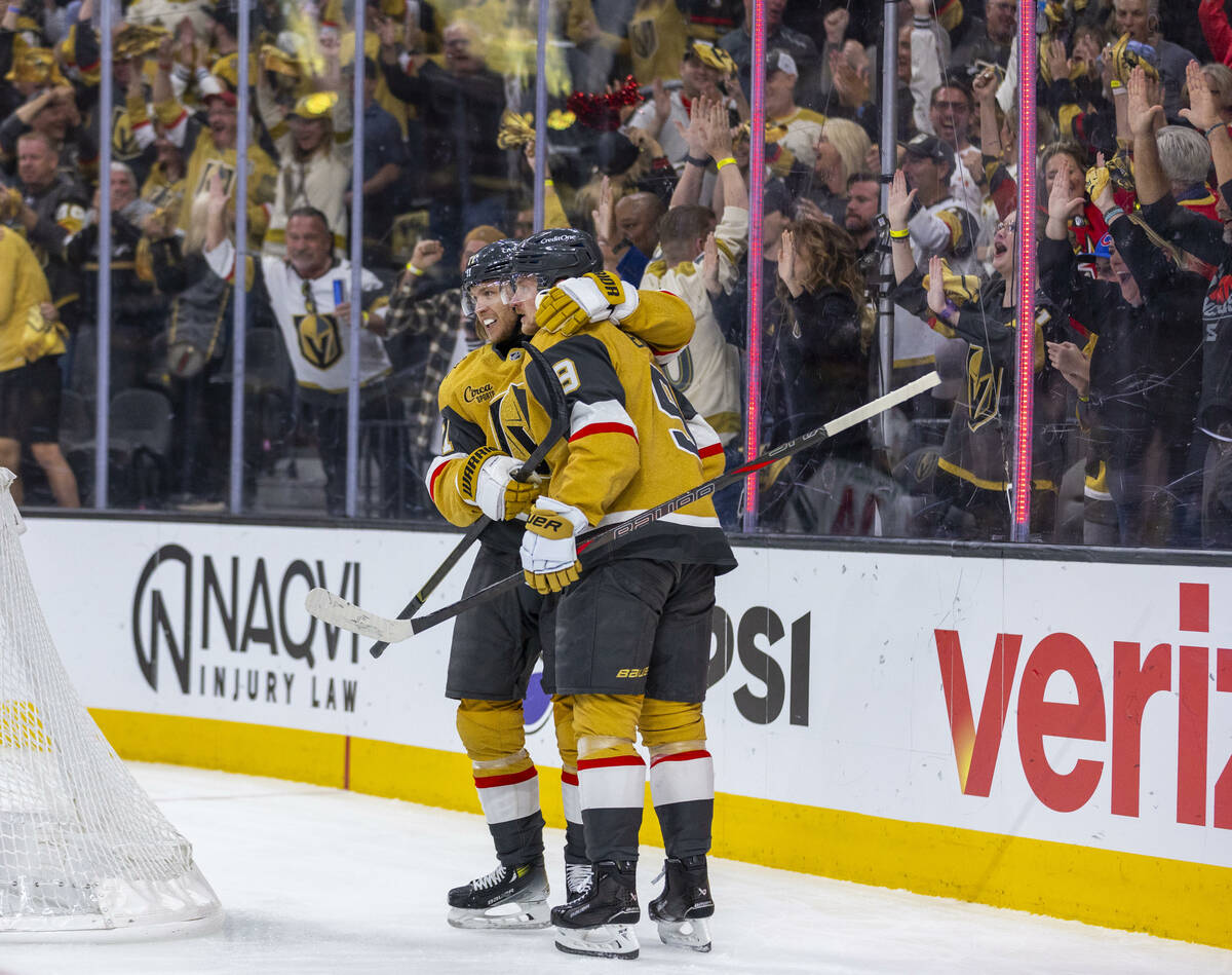Golden Knights center Jack Eichel (9) and center William Karlsson (71) celebrate their first go ...