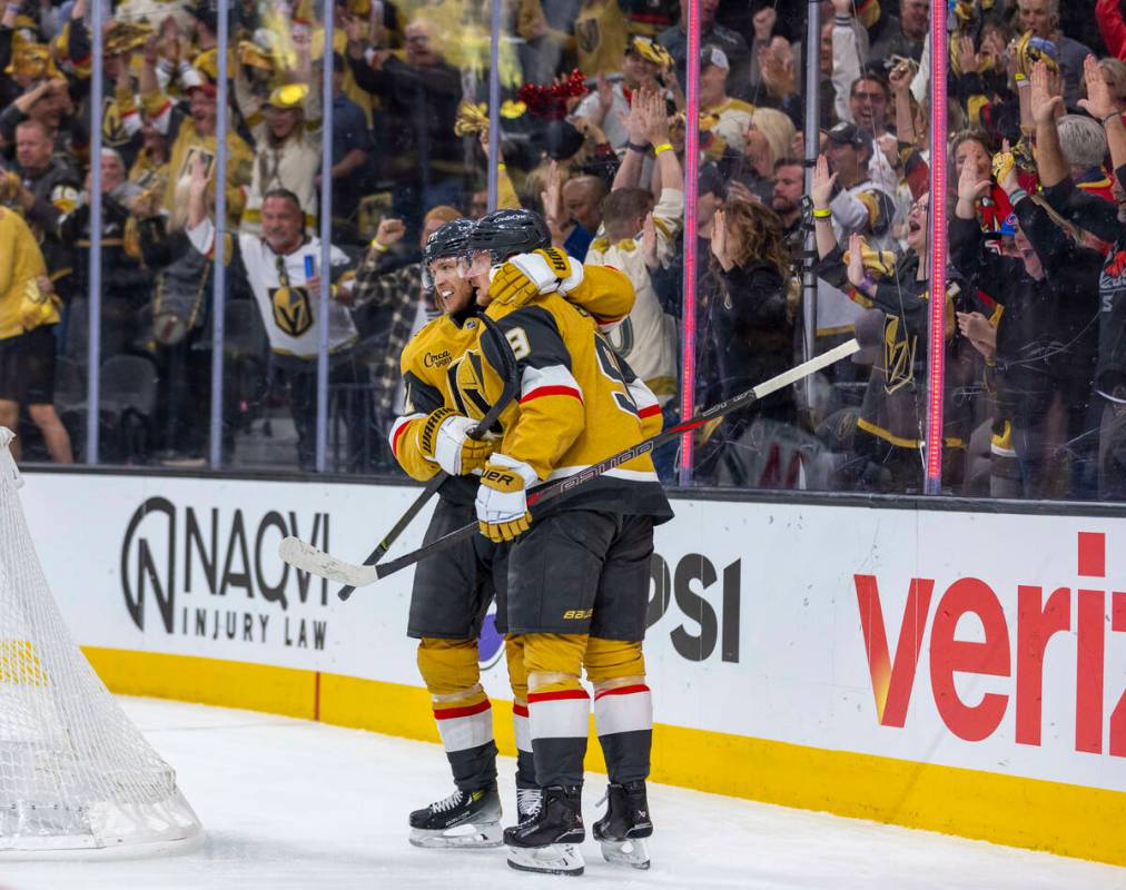 Golden Knights center Jack Eichel (9) and center William Karlsson (71) celebrate their first go ...