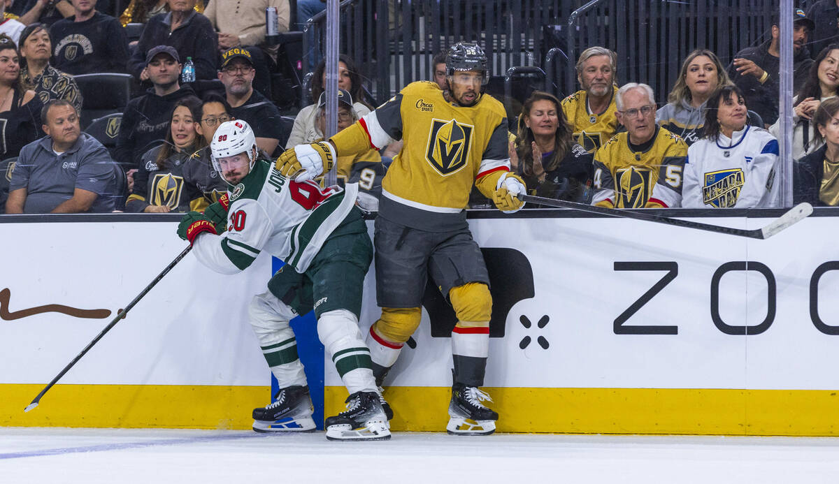 Golden Knights right wing Keegan Kolesar (55) and Minnesota Wild left wing Marcus Johansson (90 ...