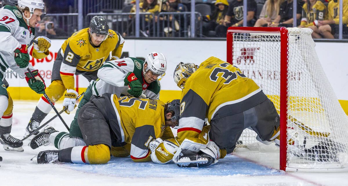 Golden Knights goaltender Adin Hill (33) stops a shot from Minnesota Wild center Joel Eriksson ...