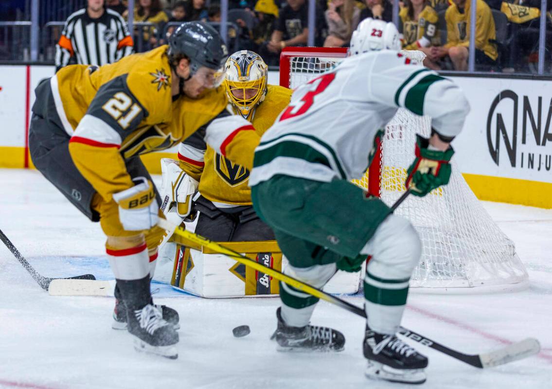 Golden Knights goaltender Adin Hill (33) deflects a shot by Minnesota Wild center Marco Rossi ( ...