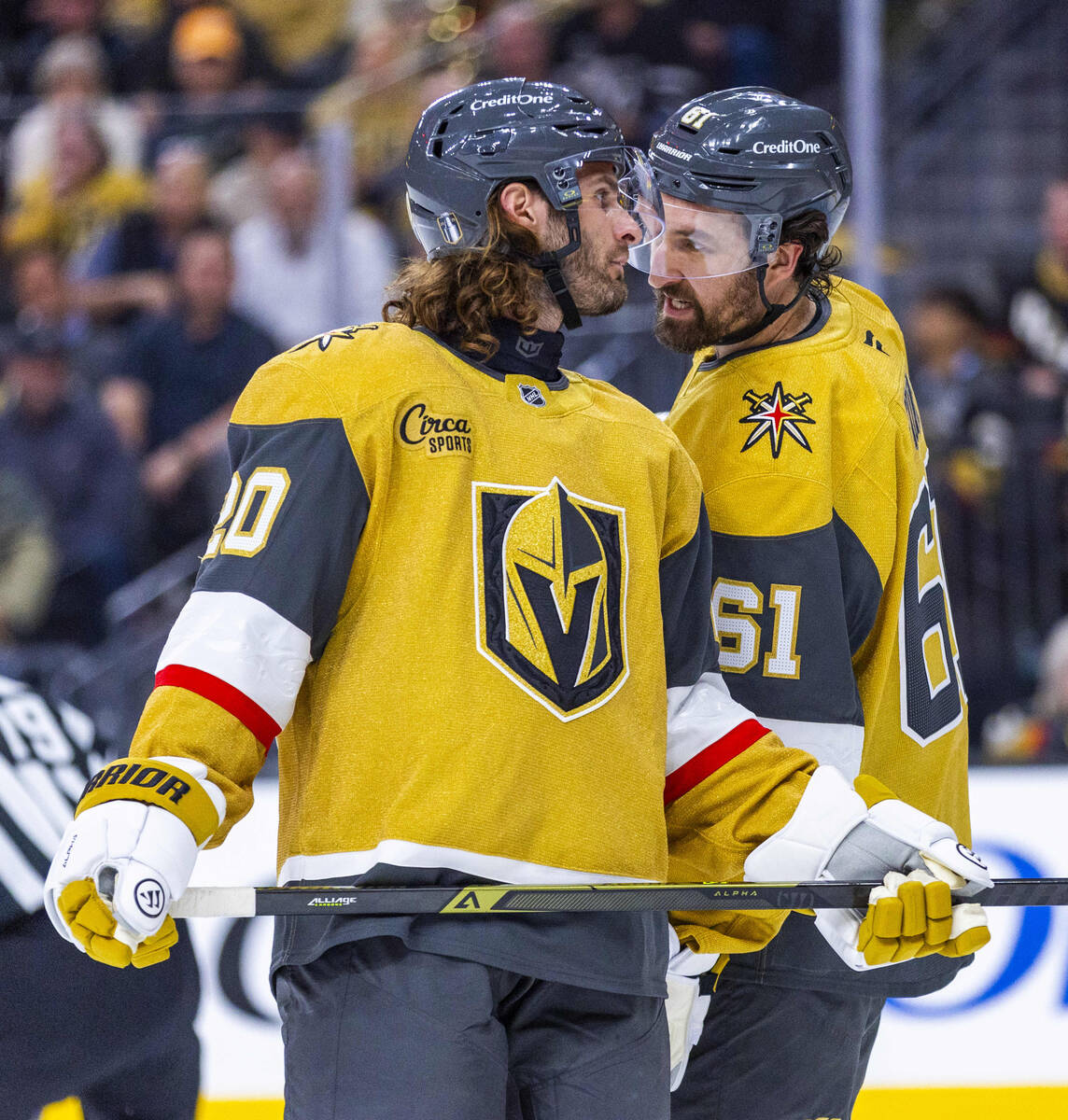 Golden Knights left wing Brandon Saad (20) and right wing Mark Stone (61) confer before another ...