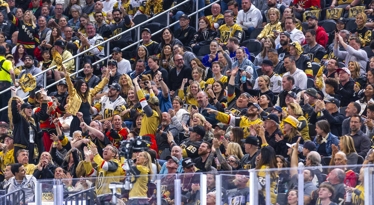 Golden Knights fans celebrate a puck sent from the ice by the Minnesota Wild during the second ...