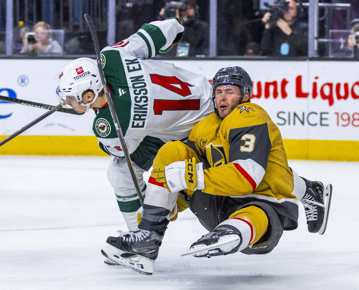 Golden Knights defenseman Brayden McNabb (3) is taken down with a side check by Minnesota Wild ...