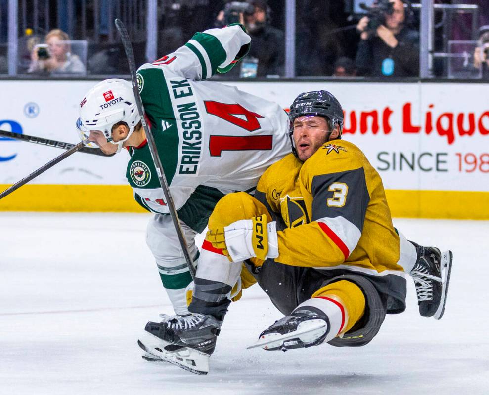 Golden Knights defenseman Brayden McNabb (3) is taken down with a side check by Minnesota Wild ...