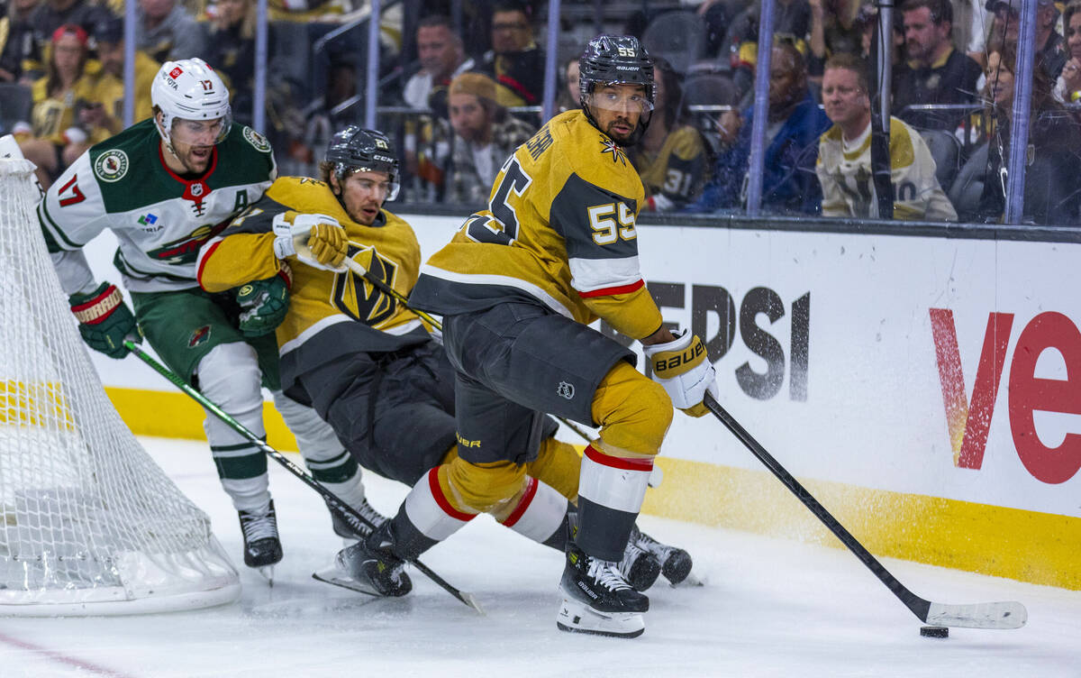 Golden Knights right wing Keegan Kolesar (55) controls the puck as Golden Knights center Brett ...