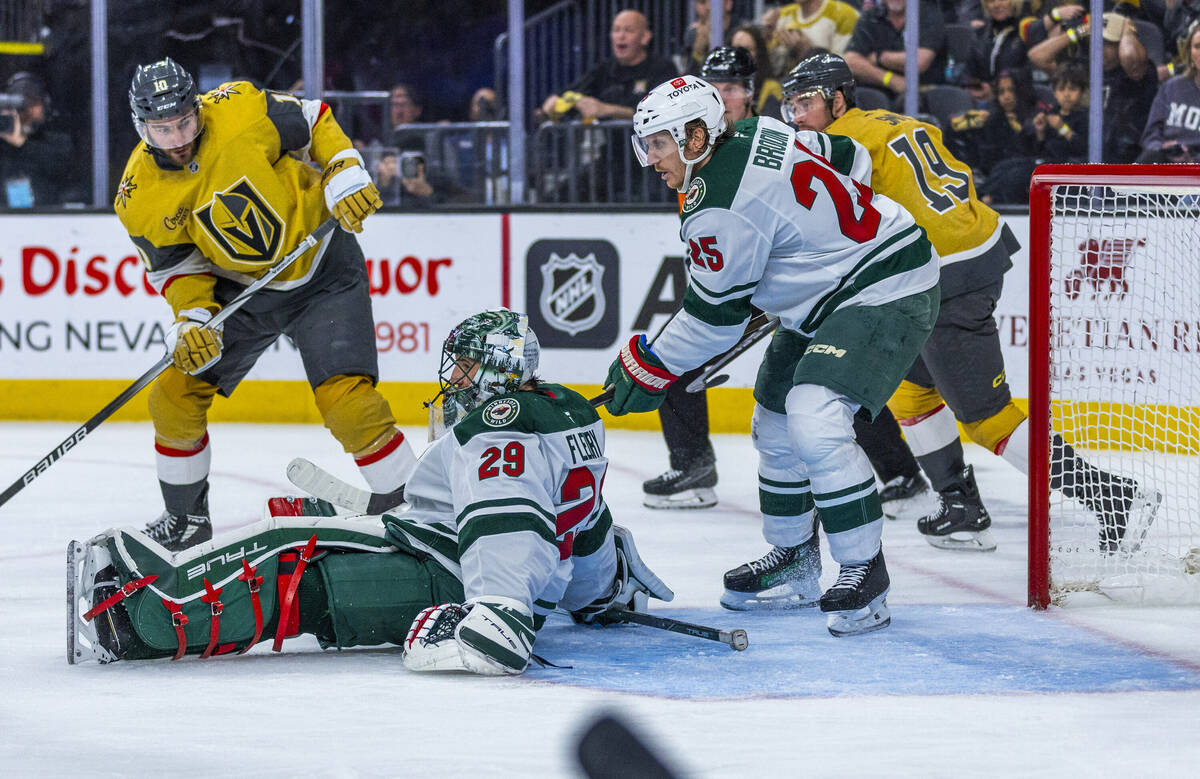 Minnesota Wild goaltender Marc-Andre Fleury (29) goes down as Golden Knights center Nicolas Roy ...