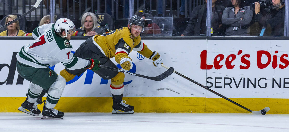 Golden Knights center Jack Eichel (9) advances the puck with Minnesota Wild defenseman Brock Fa ...