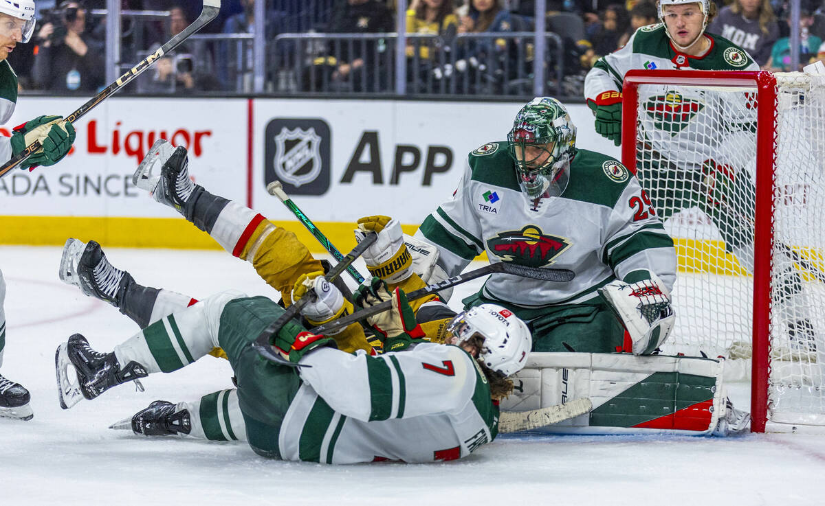 Golden Knights center William Karlsson (71) crashes into Minnesota Wild defenseman Brock Faber ...