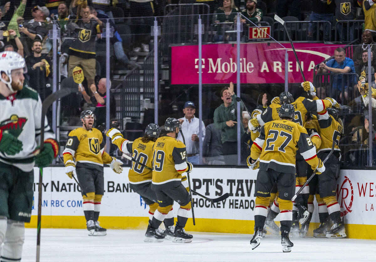 Golden Knights players celebrate their goal and win against the Minnesota Wild during the overt ...