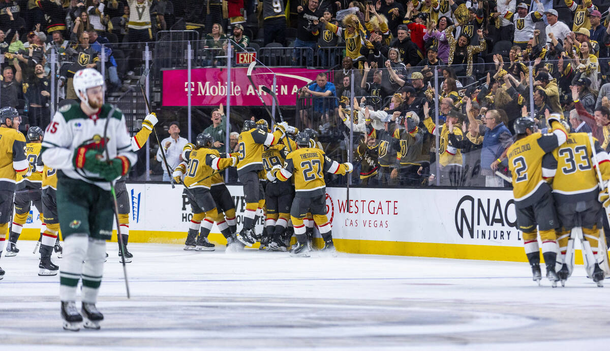 Golden Knights players celebrate their goal and win against the Minnesota Wild during the overt ...