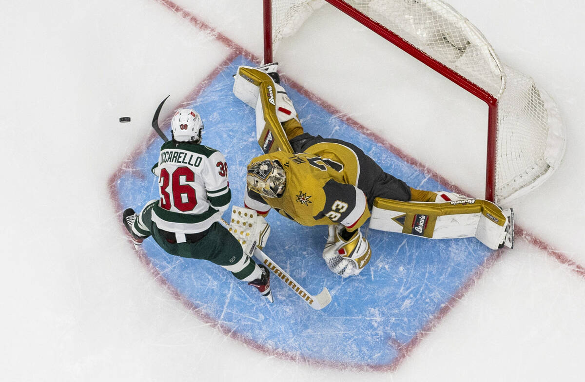 Golden Knights goaltender Adin Hill (33) is able to cover the net from a missed shot by Minneso ...