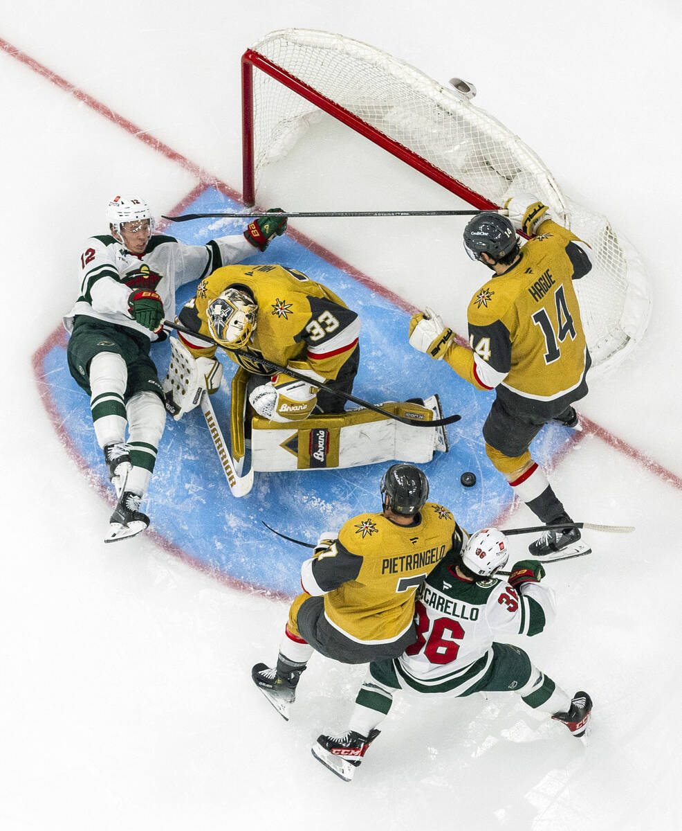 Golden Knights goaltender Adin Hill (33) blocks a shot by Minnesota Wild left wing Matt Boldy ( ...
