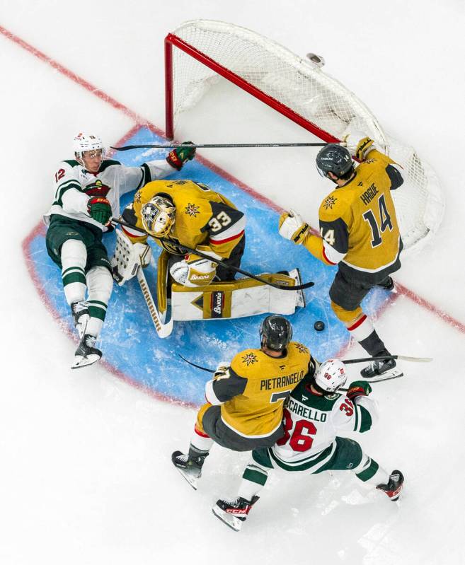 Golden Knights goaltender Adin Hill (33) blocks a shot by Minnesota Wild left wing Matt Boldy ( ...