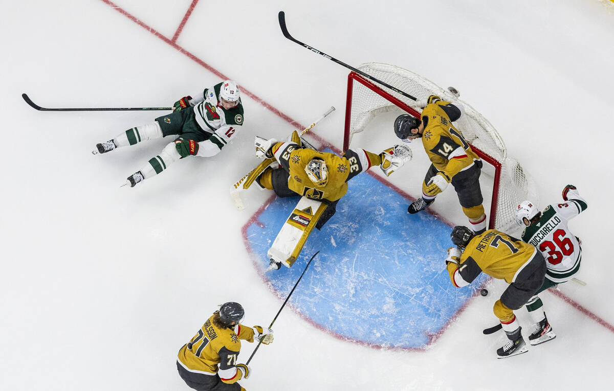 Golden Knights goaltender Adin Hill (33) blocks a shot by Minnesota Wild left wing Matt Boldy ( ...