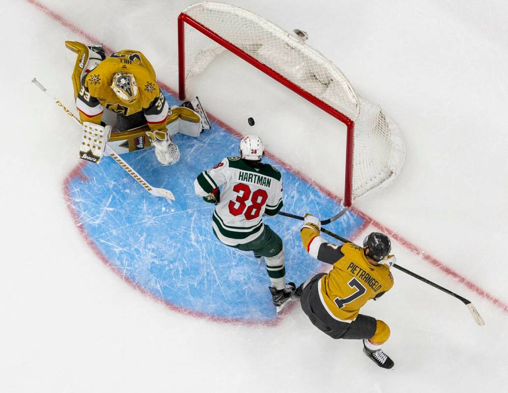Minnesota Wild right wing Ryan Hartman (38) scores on Golden Knights goaltender Adin Hill (33) ...