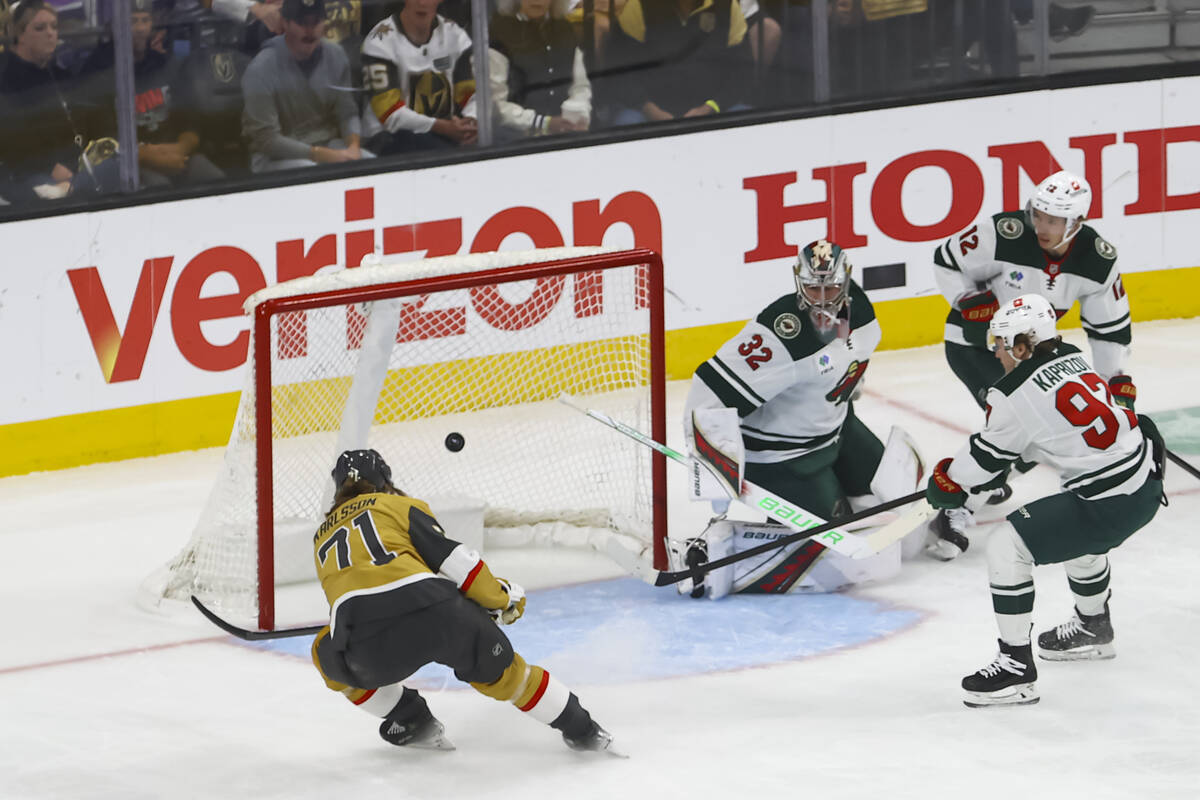 Golden Knights center William Karlsson (71) shoots past Minnesota Wild goaltender Filip Gustavs ...