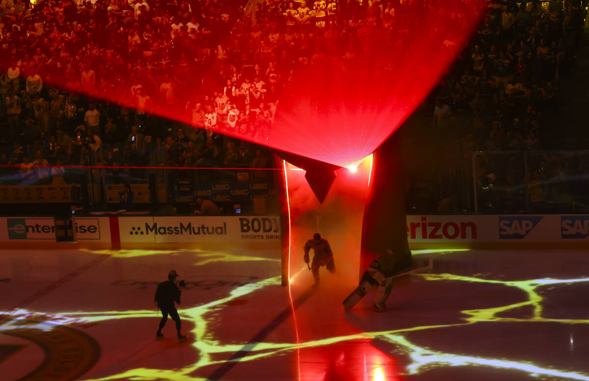 Golden Knights goaltender Adin Hill (33) and Golden Knights center Nicolas Roy (10) skate onto ...