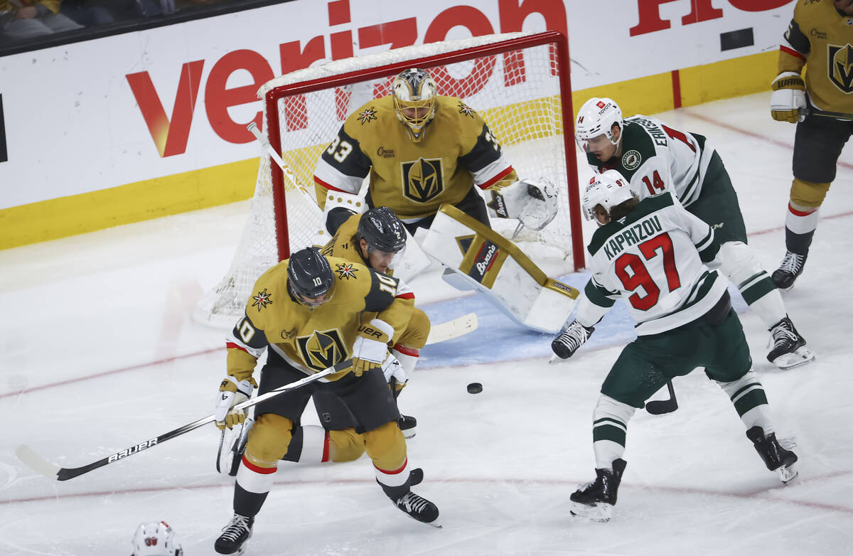Golden Knights goaltender Adin Hill (33), defenseman Zach Whitecloud (2) and center Nicolas Roy ...