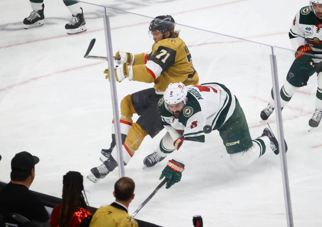 Golden Knights center William Karlsson (71) and Minnesota Wild defenseman Jake Middleton (5) ge ...