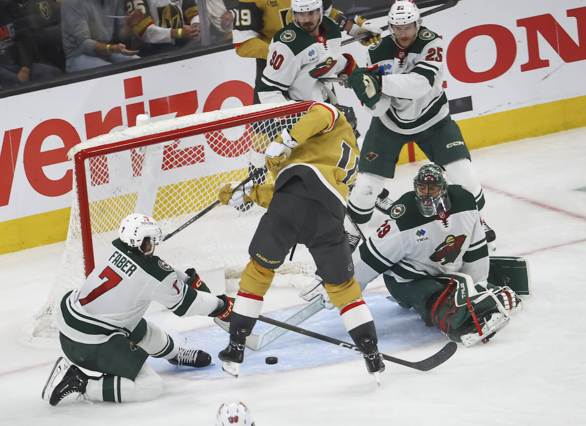 Minnesota Wild defenseman Brock Faber (7) and goaltender Marc-Andre Fleury (29) look to block t ...