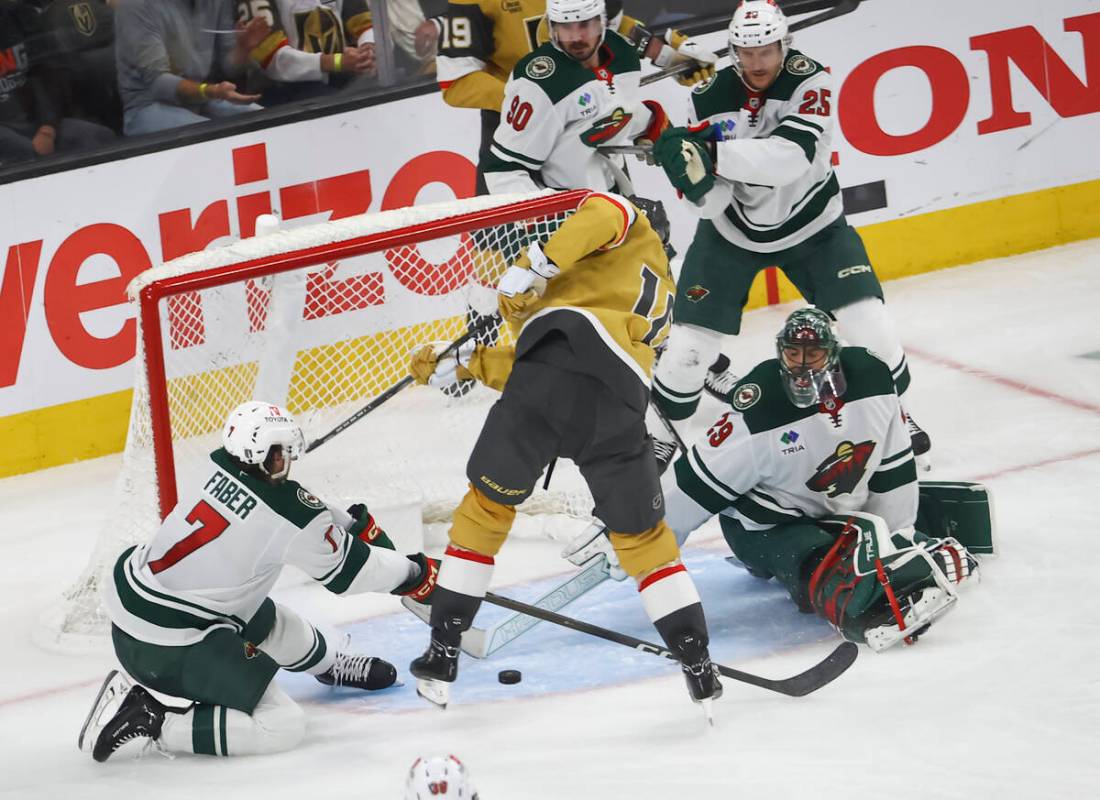 Minnesota Wild defenseman Brock Faber (7) and goaltender Marc-Andre Fleury (29) look to block t ...
