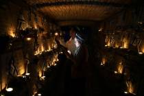 People light candles at Mount Herzl military cemetery in Jerusalem on the eve of Israel's annua ...