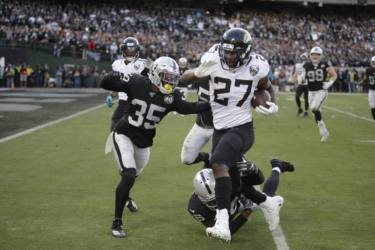 Jacksonville Jaguars running back Leonard Fournette (27) runs with the ball as Oakland Raiders ...