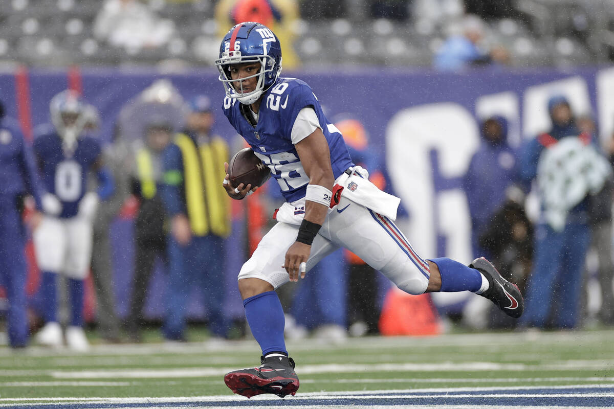New York Giants running back Saquon Barkley (26) runs the ball during the second half of an NFL ...