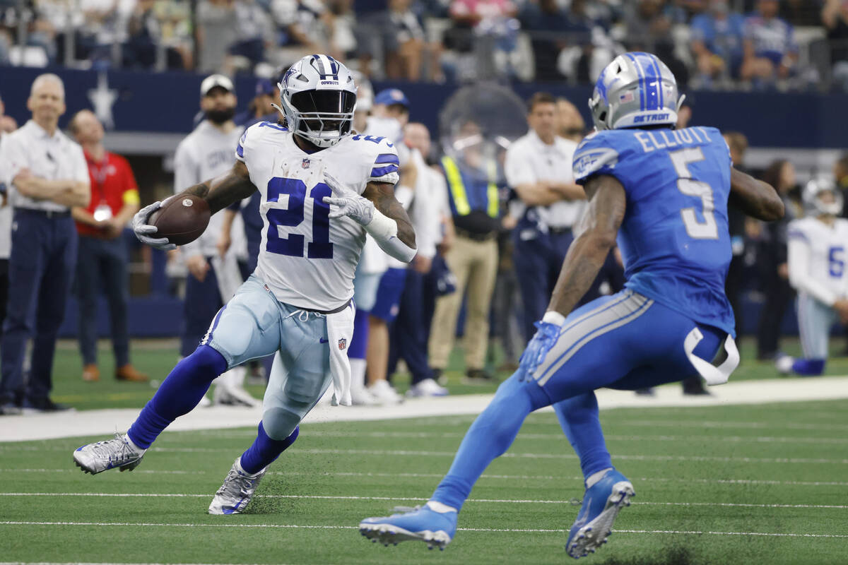 Dallas Cowboys running back Ezekiel Elliott is defended by Detroit Lions safety DeShon Elliott ...