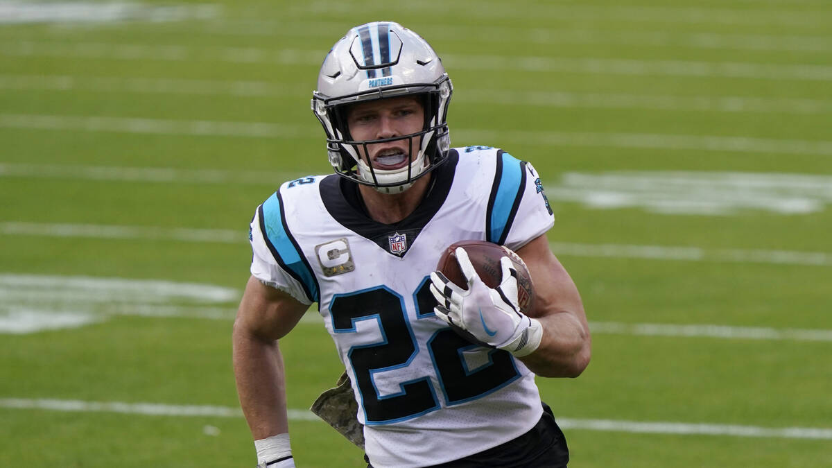 Carolina Panthers running back Christian McCaffrey runs with the ball during an NFL football ga ...