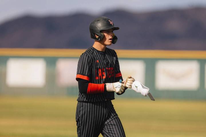 Las Vegas pitcher Hunter Iverson takes off his batting gear after making a run to second base d ...