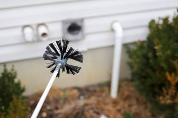 Cleaning the dryer vent requires a round brush on a long flexible snake. (Getty Images)