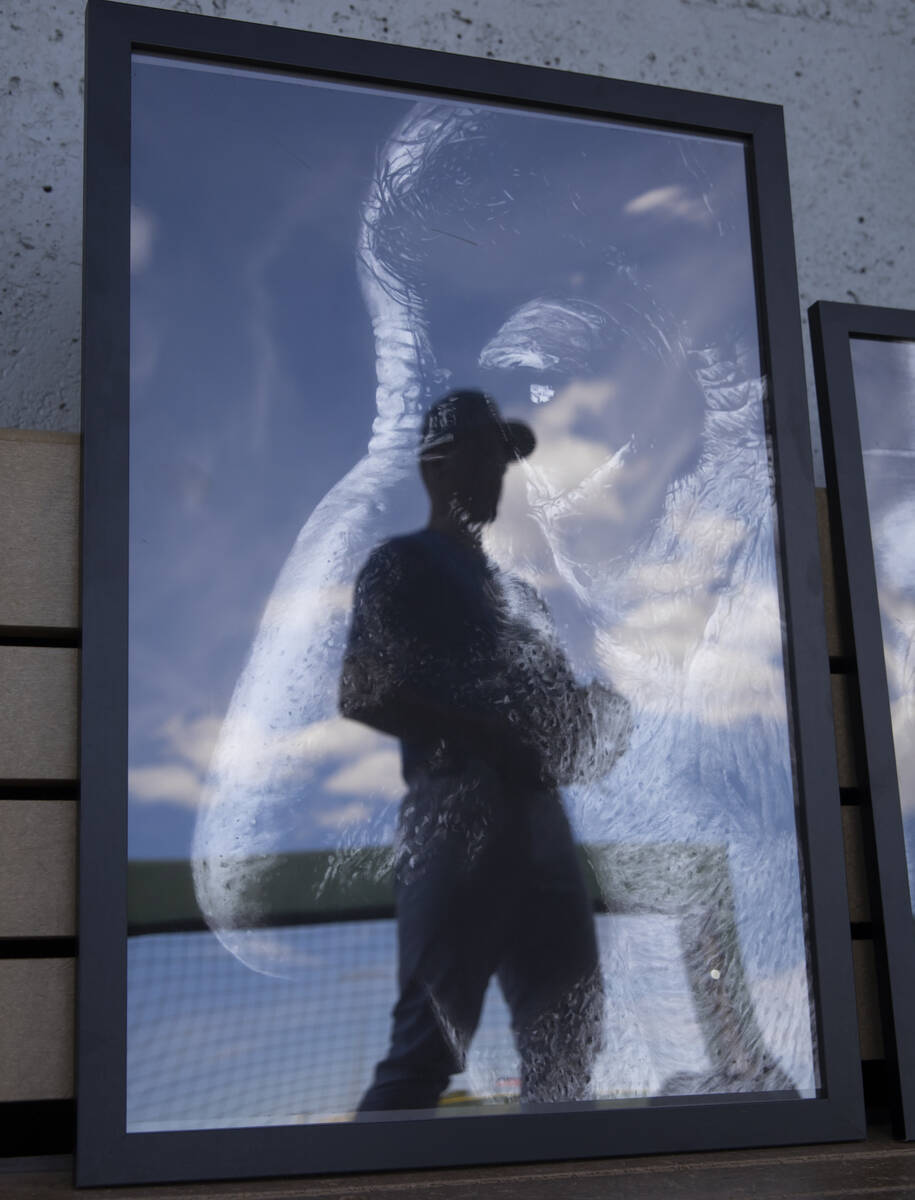 Bishop Gorman pitcher James Whitaker is seen reflected in one of his charcoal portraits in the ...