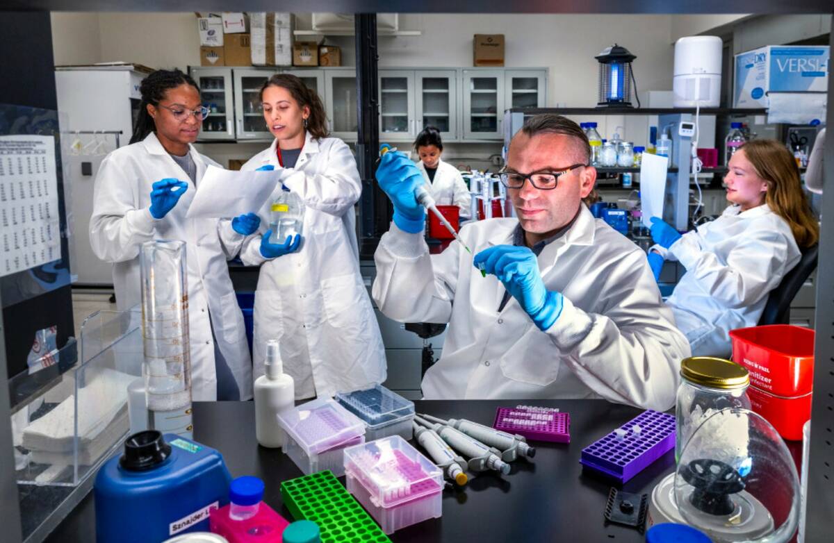 Dr. Lukasz Sznajder sets up the polymerase chain reaction to detect RNA changes with the assist ...