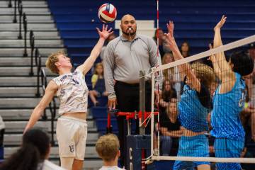 Coronado outside hitter Dexter Brimhall hits the ball over the net during a volleyball game bet ...