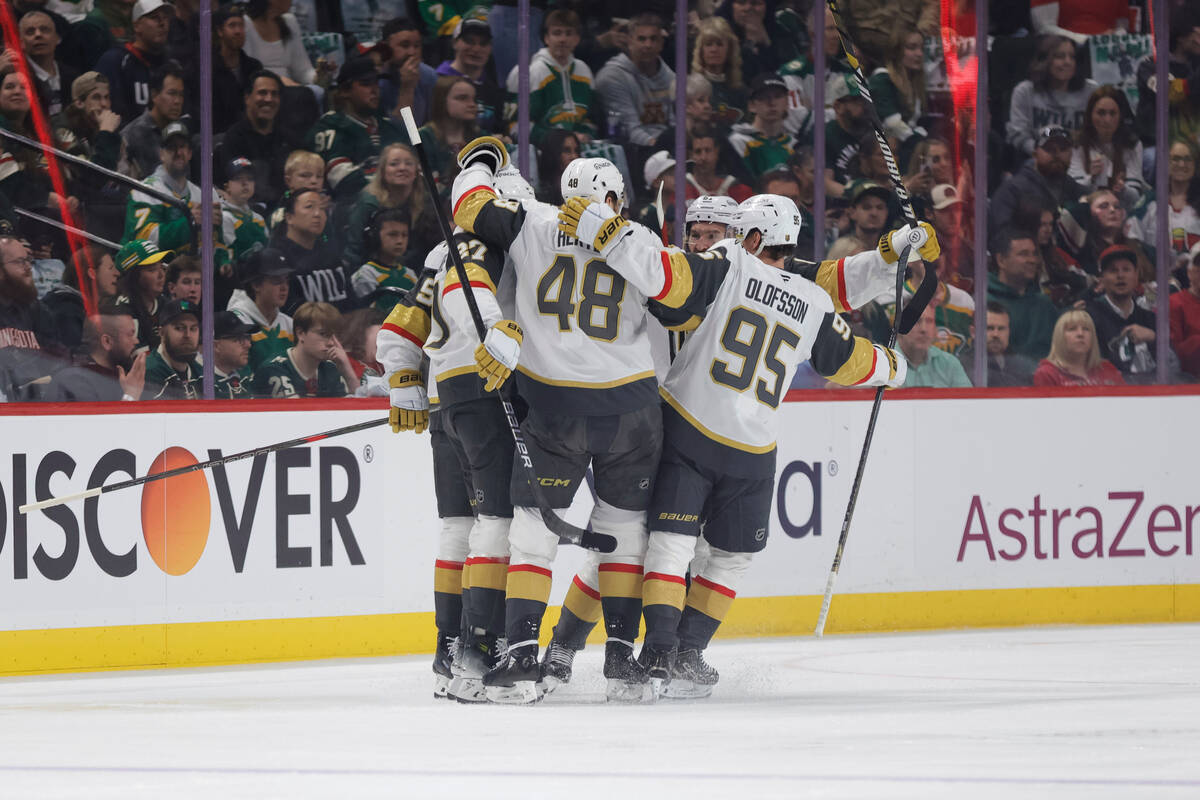 Vegas Golden Knights defenseman Shea Theodore (27) celebrates with teammates after scoring a po ...