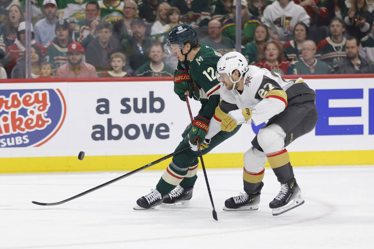 Minnesota Wild left wing Matt Boldy (12) and Vegas Golden Knights defenseman Shea Theodore (27) ...